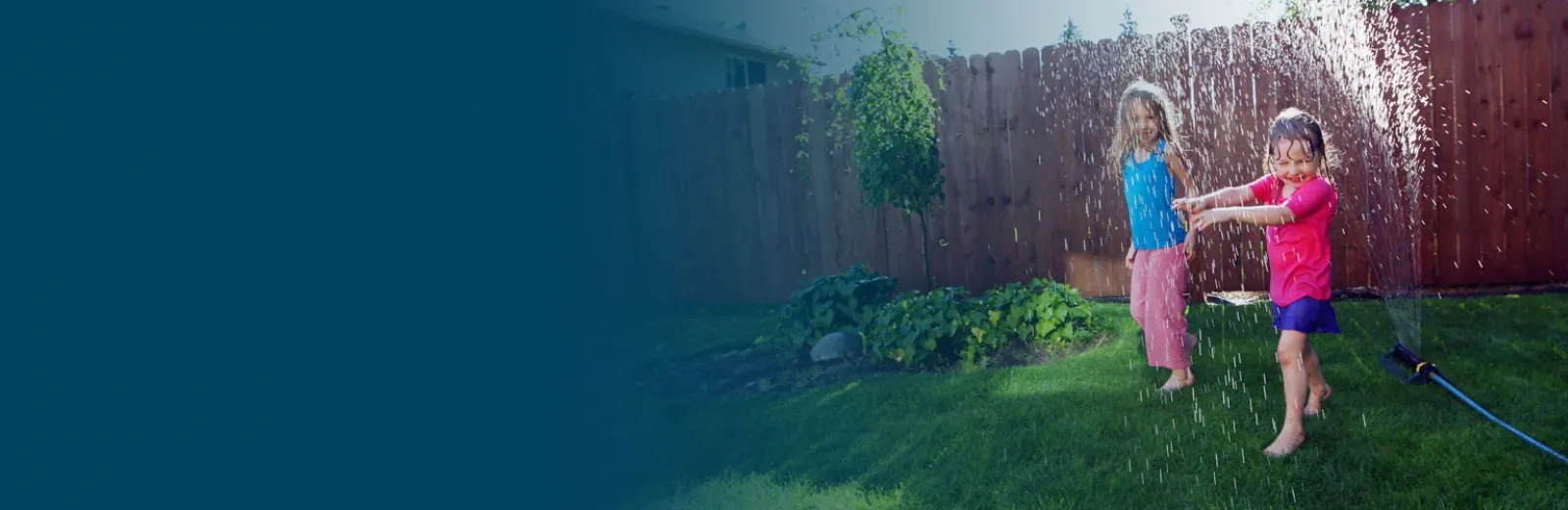 kids playing in sprinkler